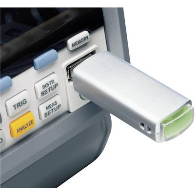 A USB stick is plugged into a measuring device port to store data. Buttons with labels such as 'ANALYZE' and 'MEMORY' are visible.