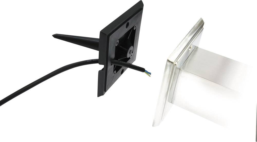 A black plastic spike with a cable stands on the left side of the image. On the right, a transparent, square housing can be seen.