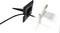 A black plastic spike with a cable stands on the left side of the image. On the right, a transparent, square housing can be seen.