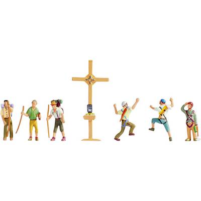 Several miniature figures climbing a mountain stand around a summit cross. Some are raising their arms in jubilation, while others are leaning on walking poles.