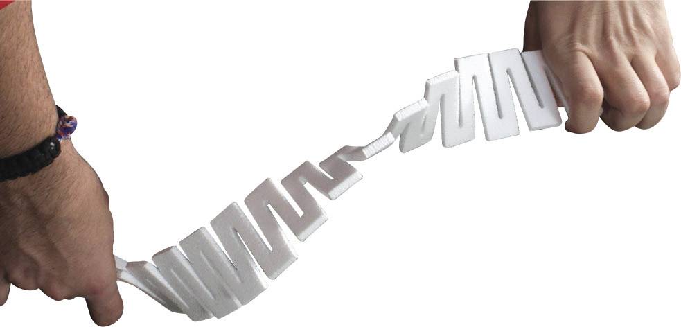 A hand holds a series of white, rectangular plastic pieces connected by joints. The shape is curved.