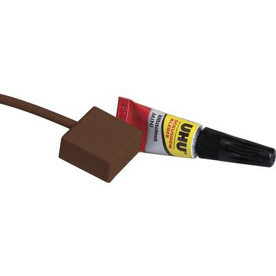 A tube of superglue next to a brown cable with a rectangular plug.