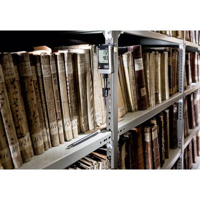 Shelves with old books in a library, a thermo-hygrometer displays '12°C' and '48%', a pen rests on the shelf.