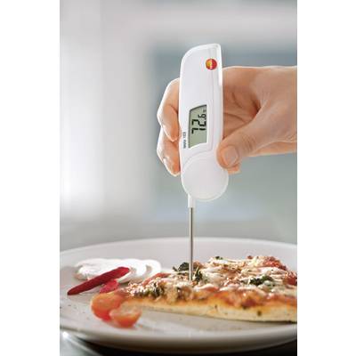 A hand is holding a digital thermometer in a slice of pizza. The display shows 72.6 degrees Celsius.