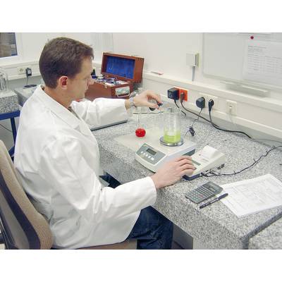 A scientist in a white lab coat is conducting a chemical measurement using a beaker and analytical equipment in the laboratory.