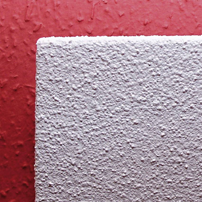 Close-up of a red-painted wall with a white structural demarcation on the right, showing various textures.