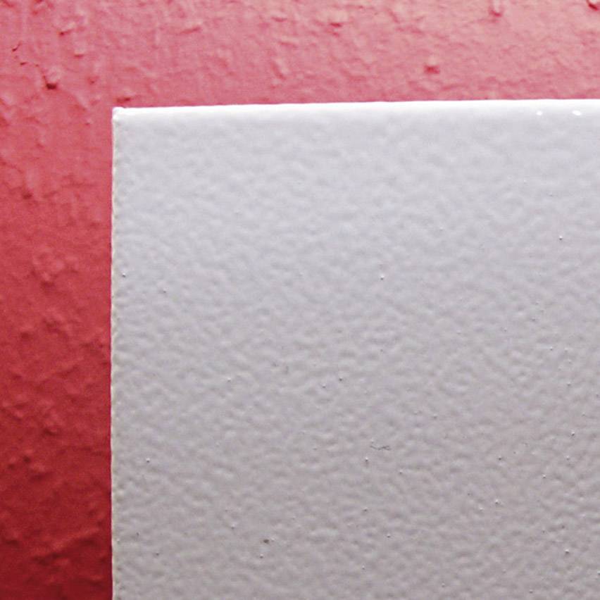A simple, rectangular object with a smooth, light surface borders a structured, red background area.