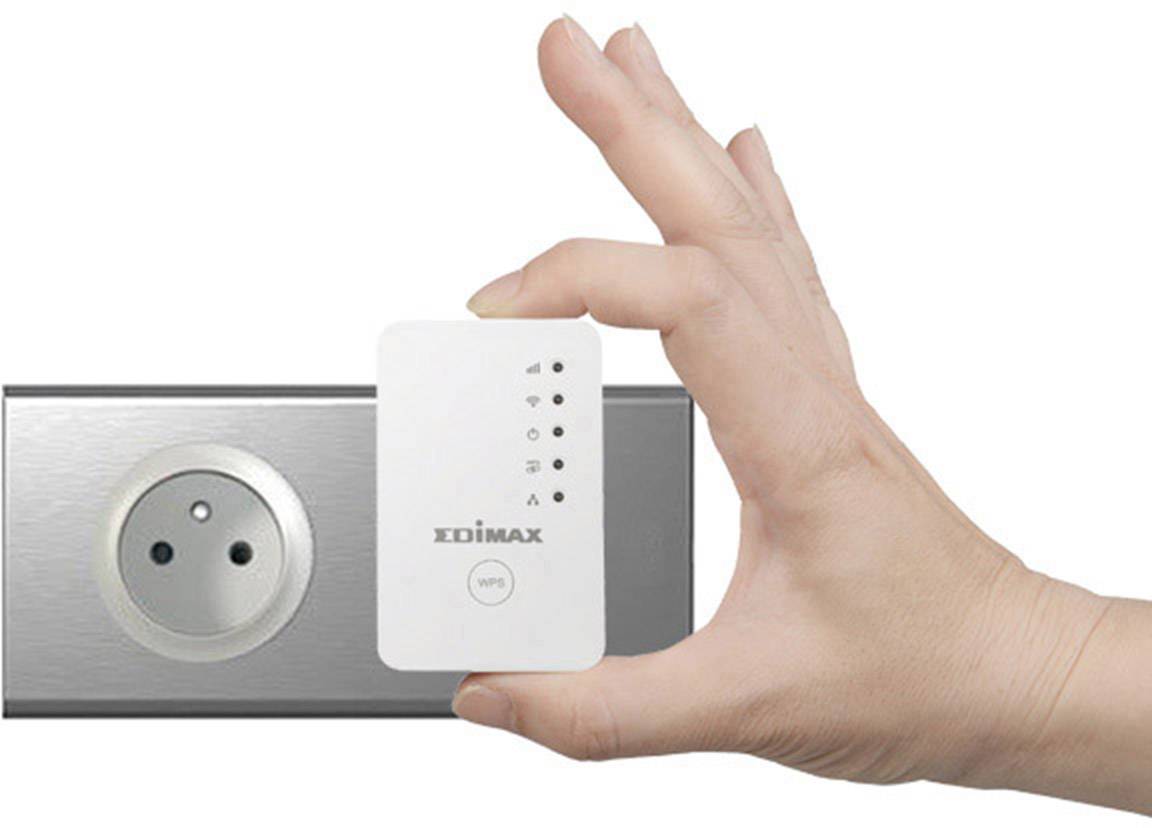 A hand is holding a Wi-Fi extender near a plug socket, demonstrating the straightforward handling and installation of the device.