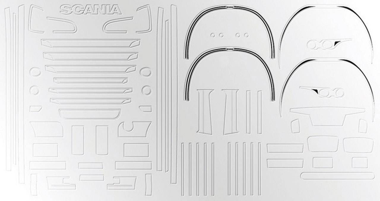 A white sheet metal with punched-out shapes representing automotive parts. 'Scania' is written in the top left corner. Contains curves and lines.