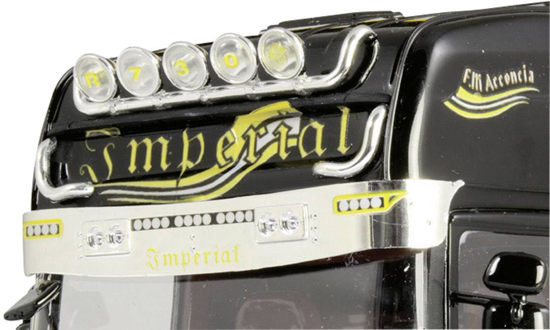 A lorry with stylised yellow and silver embellishments. At the top, six round lights and the word 'Imperial' are visible.
