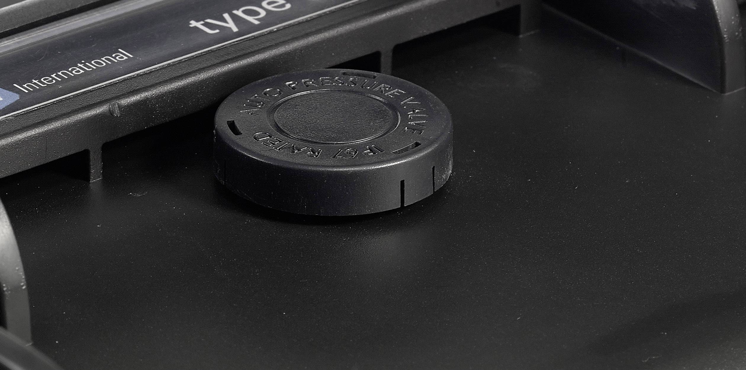 A black rotary knob on a device, surrounded by a housing. Partial labels are visible in the top left.