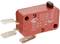 A red micro switch with two metal contacts and manufacturer details, used for controlling electrical circuits.