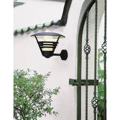 Wall light on a white wall, next to a green fence, emits soft light.