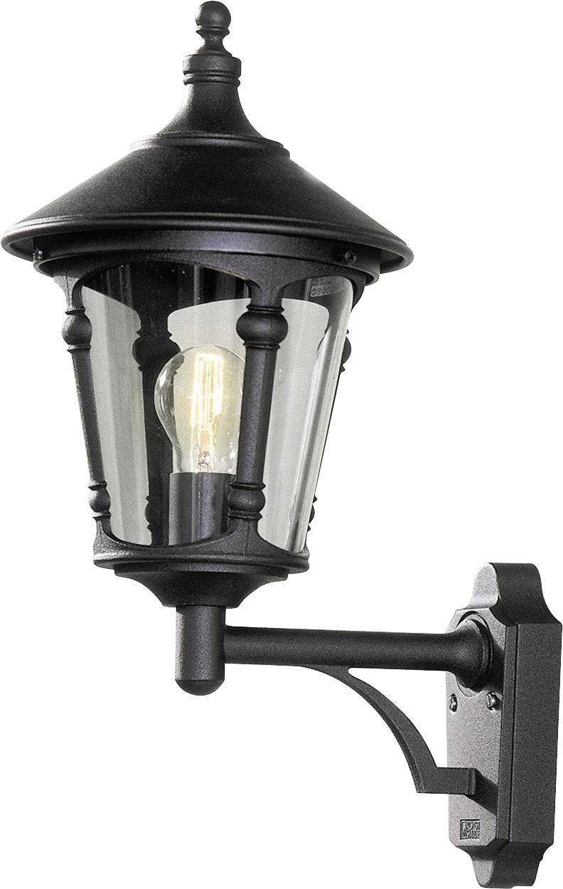 Black outdoor wall light with clear glass, in a traditional design, mounted on a wall. Ideal for exterior lighting.