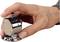 A hand holds a mechanical counting device displaying '236'. Device made of metal, held in the palm, typical of manual counting.