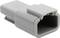 'Grey plastic connector, rectangular in shape, with rounded edges and an open end for electrical connections.'