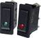 Two black toggle switches, one with a green light and one with a red light, on a white background.