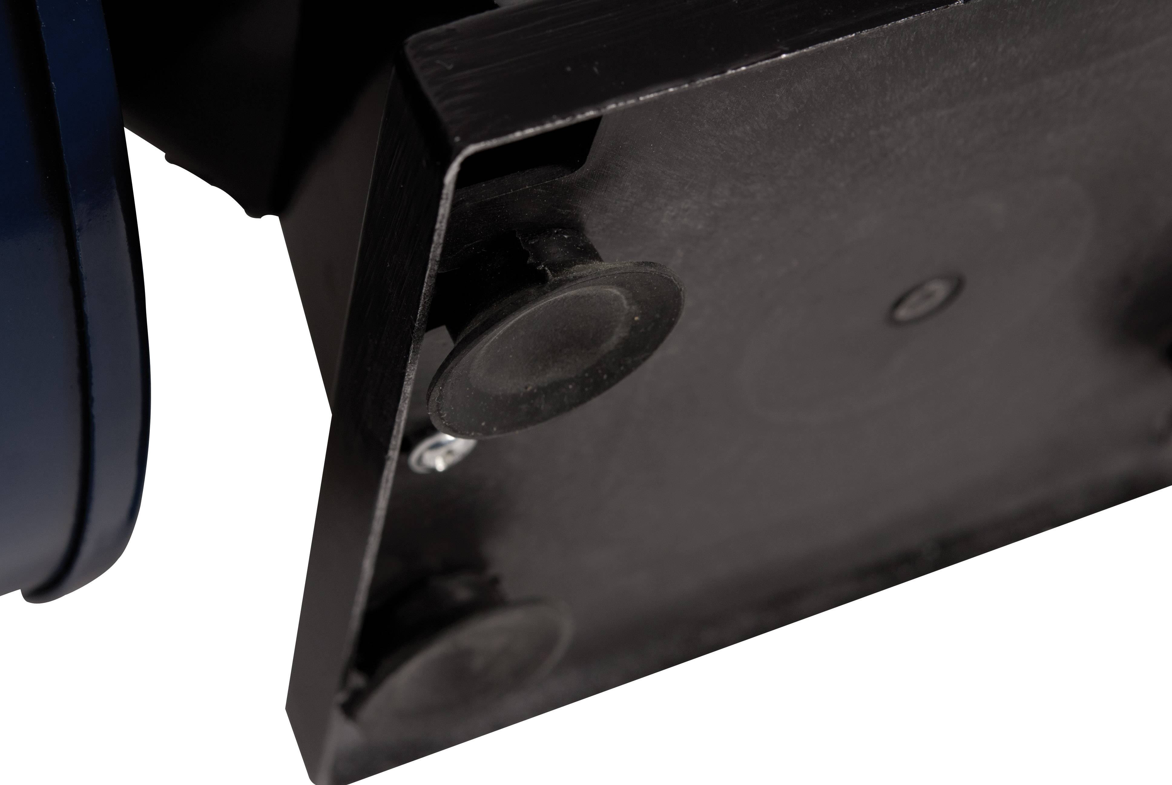 Close-up of the underside of a black plastic device with round feet, possibly part of a machine or piece of equipment.