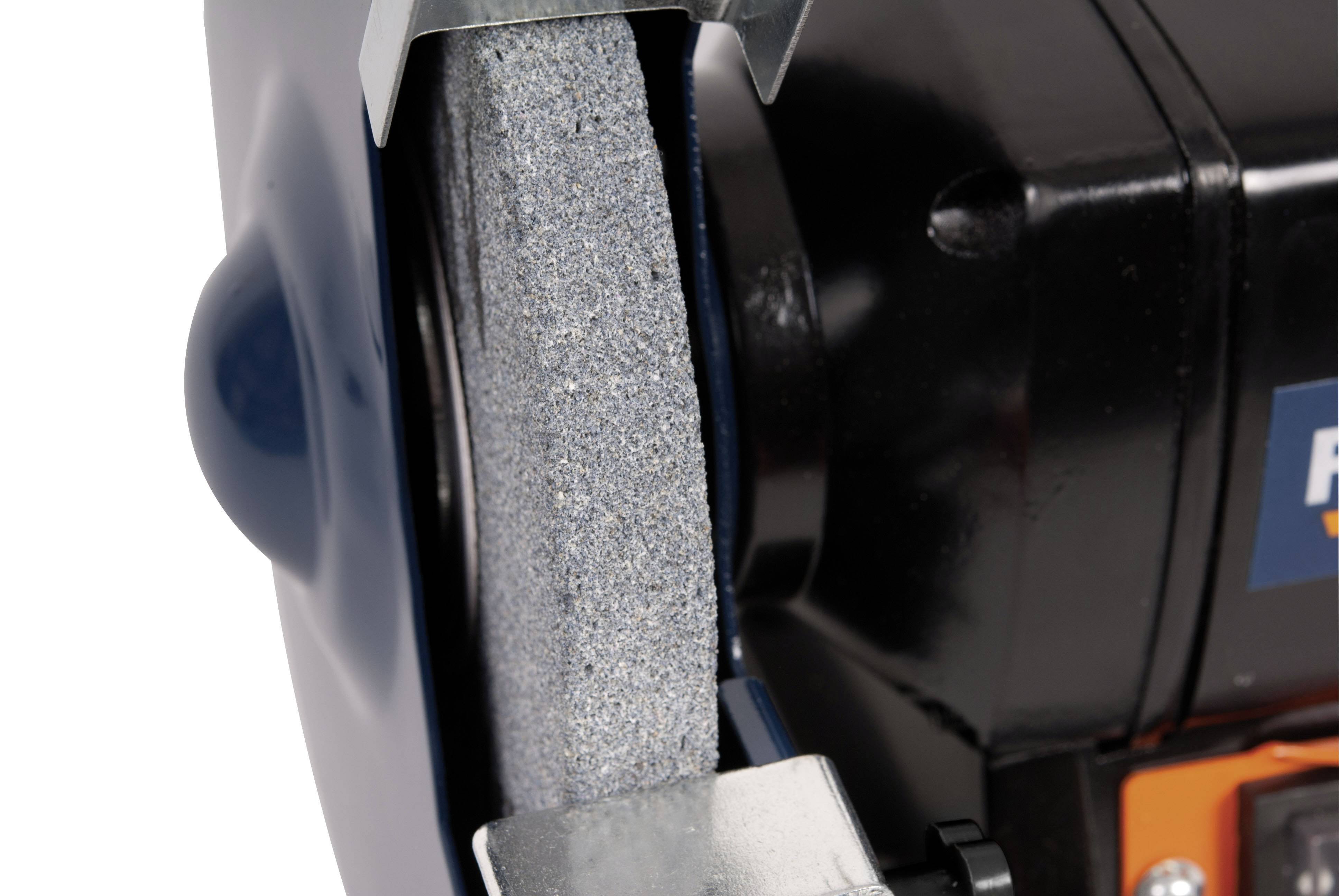 A grinding wheel with a rotating grinding disc in close-up. Device used for sharpening or smoothing materials.