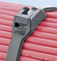 A black plastic strap with a fastening buckle lies on a red, ribbed surface against a blue background.