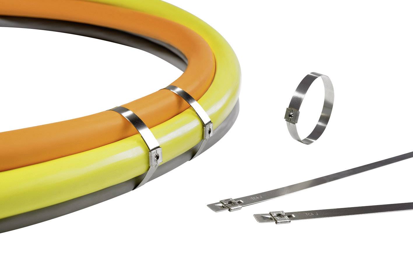 Several cables in orange, yellow, and grey, secured with metallic cable ties. Two loose cable ties are lying beside them.