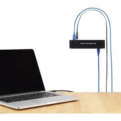 An open laptop is connected to a USB hub with multiple ports for various devices.