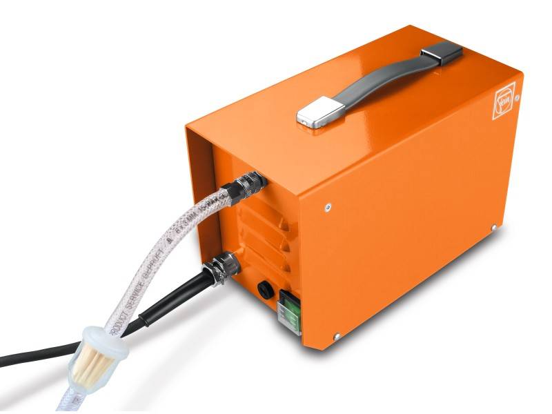 Orange device with a handle and connections, possibly a pump or a filter. A transparent tube leads out.