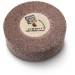 A round grinding stone with a coarse-grained surface and a label in the centre.