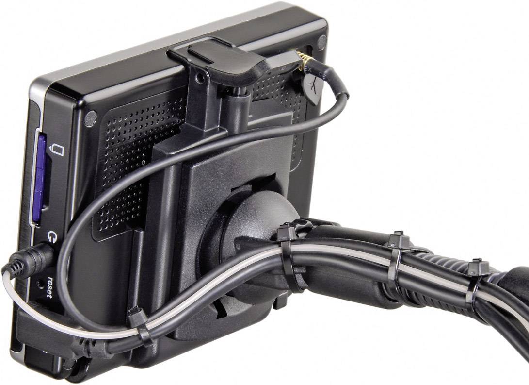 Back of a portable GPS device mounted on a vehicle holder, with power cable connected.