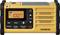 Portable yellow emergency radio with solar cell, hand crank, display showing 'FM 100.7', volume control, tuning dial, and antenna socket.
