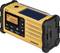 A portable yellow radio with solar charging functionality, displaying the frequency 100.7. Buttons for volume control and station selection.