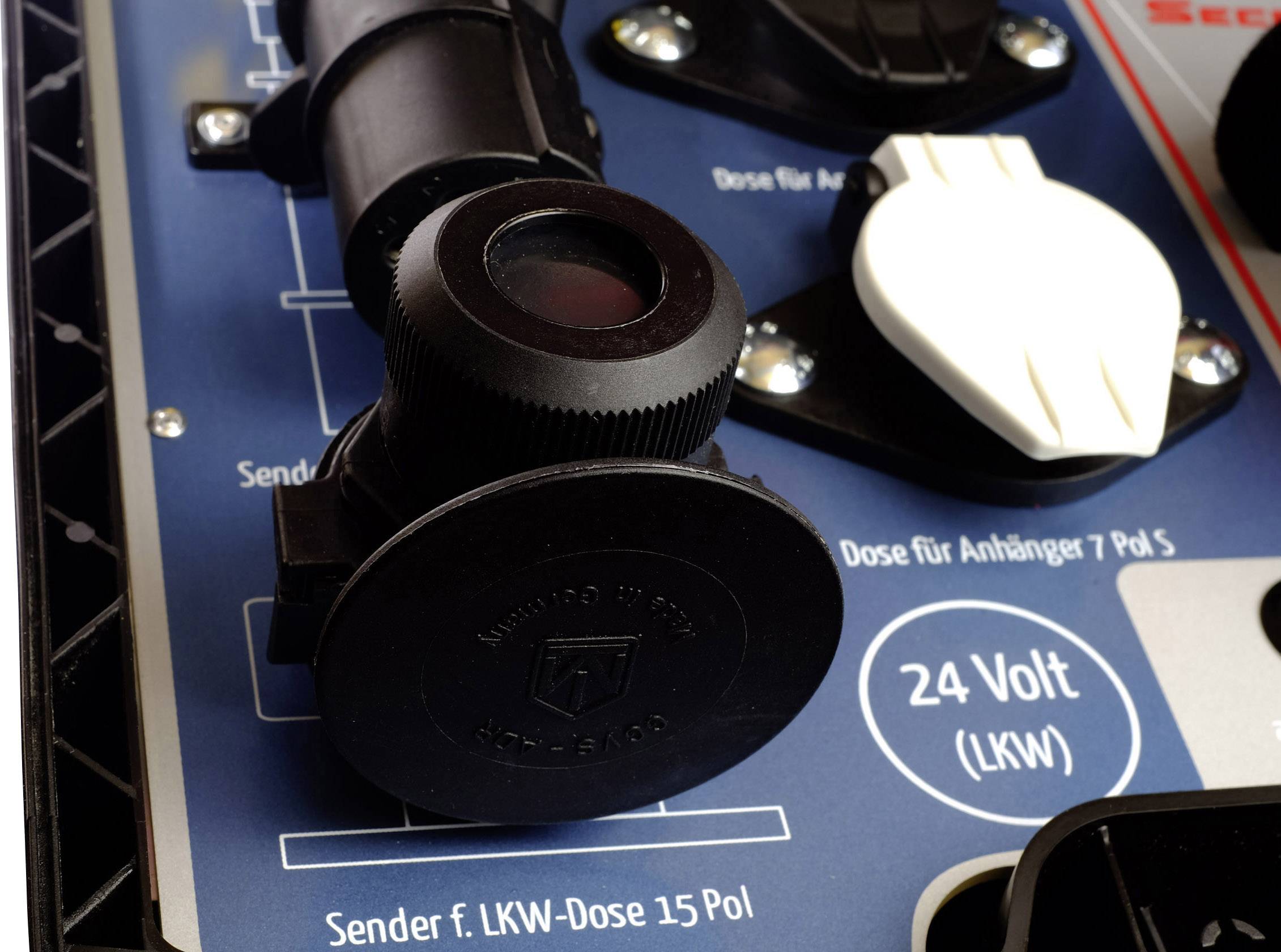 Close-up of a blue control panel with various sockets, including a '24 volt (lorry)' socket and a trailer socket.