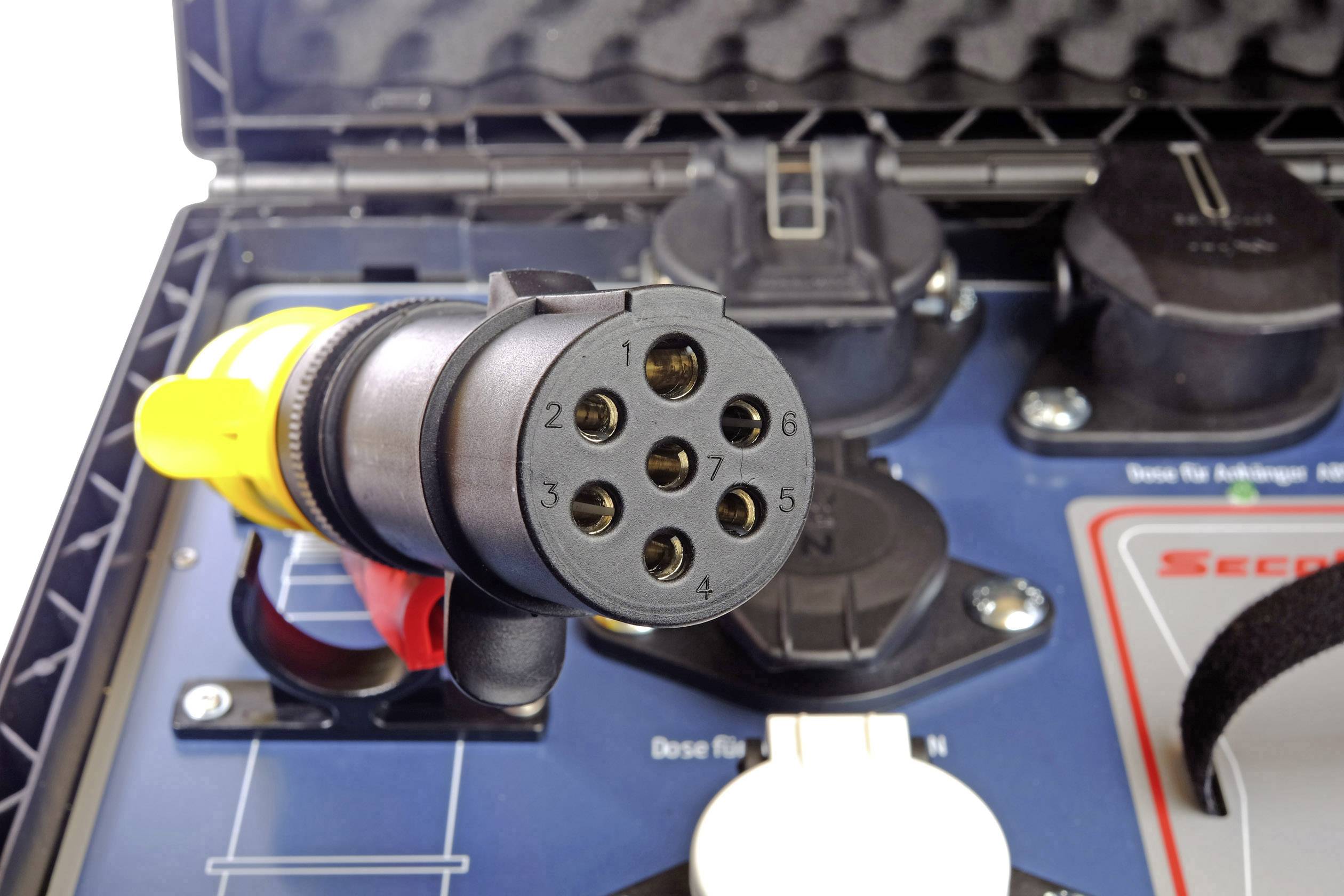 Close-up of an electric vehicle charging plug in a case. It shows the connection contacts, linked with charging ports in the background.