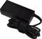 Black power supply with a long, coiled cable.