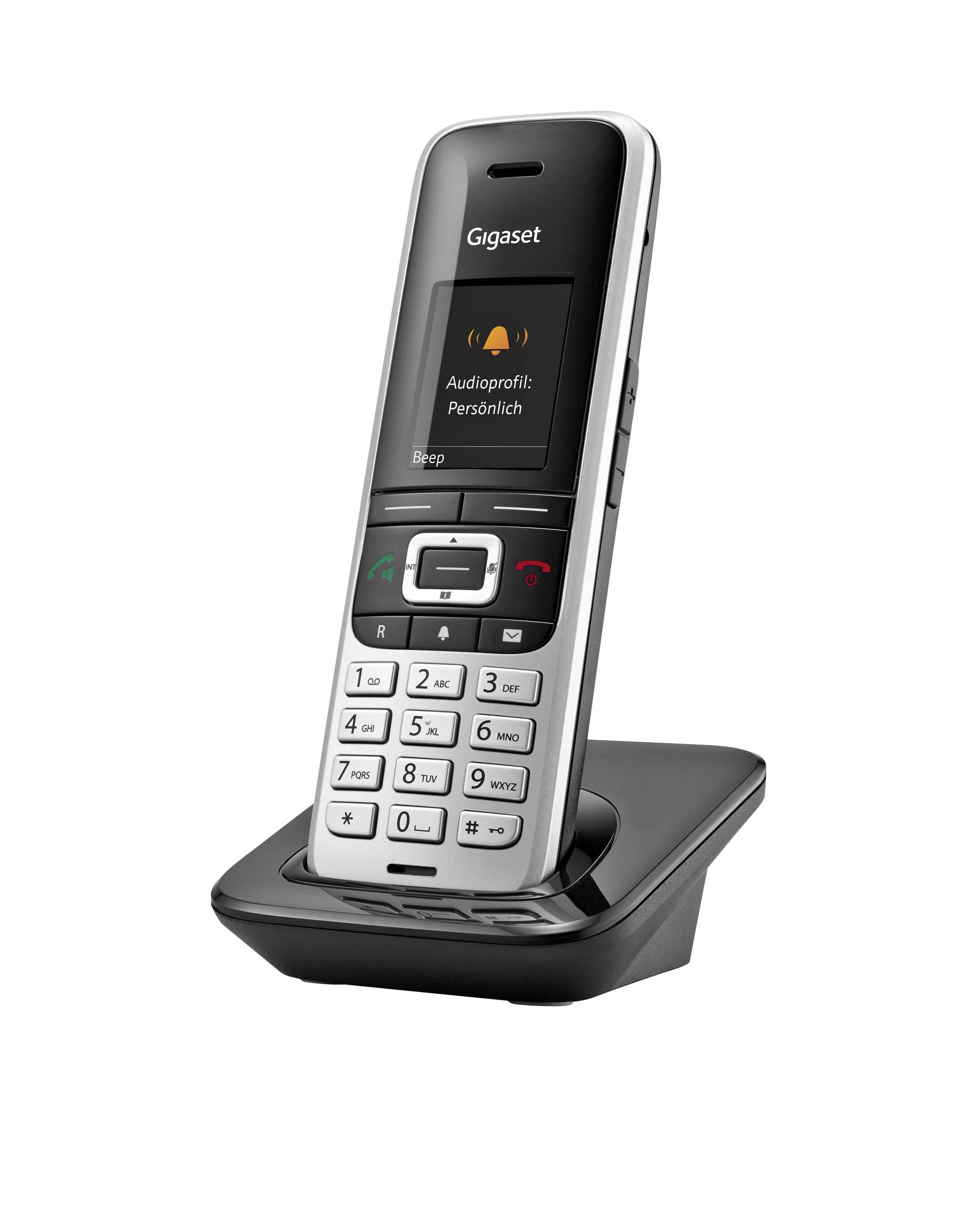 Cordless Gigaset telephone in charging station, display showing 'Audio profile: Personal'. Keypad beneath, with buttons for call answering and ending.