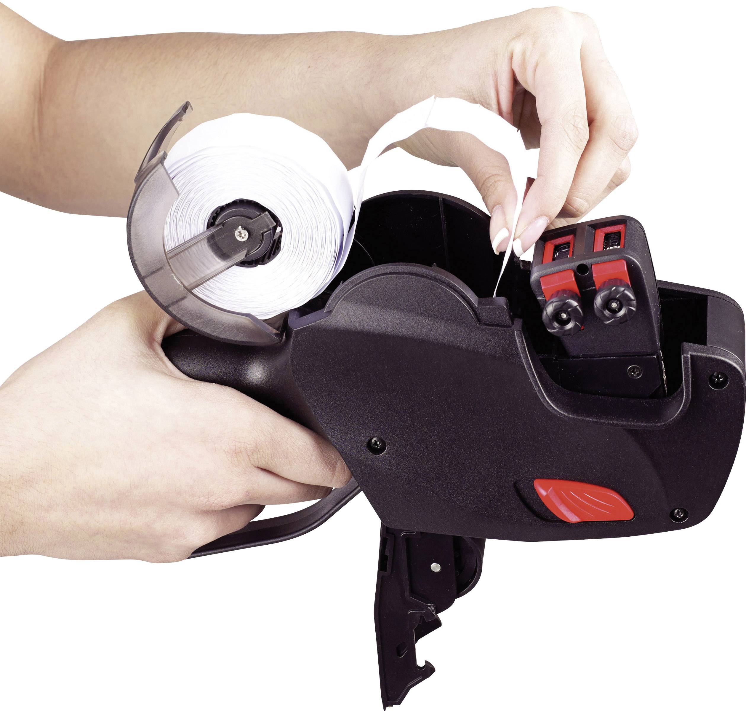 A person is loading a price labelling device with a label roll, ready to print price tags.
