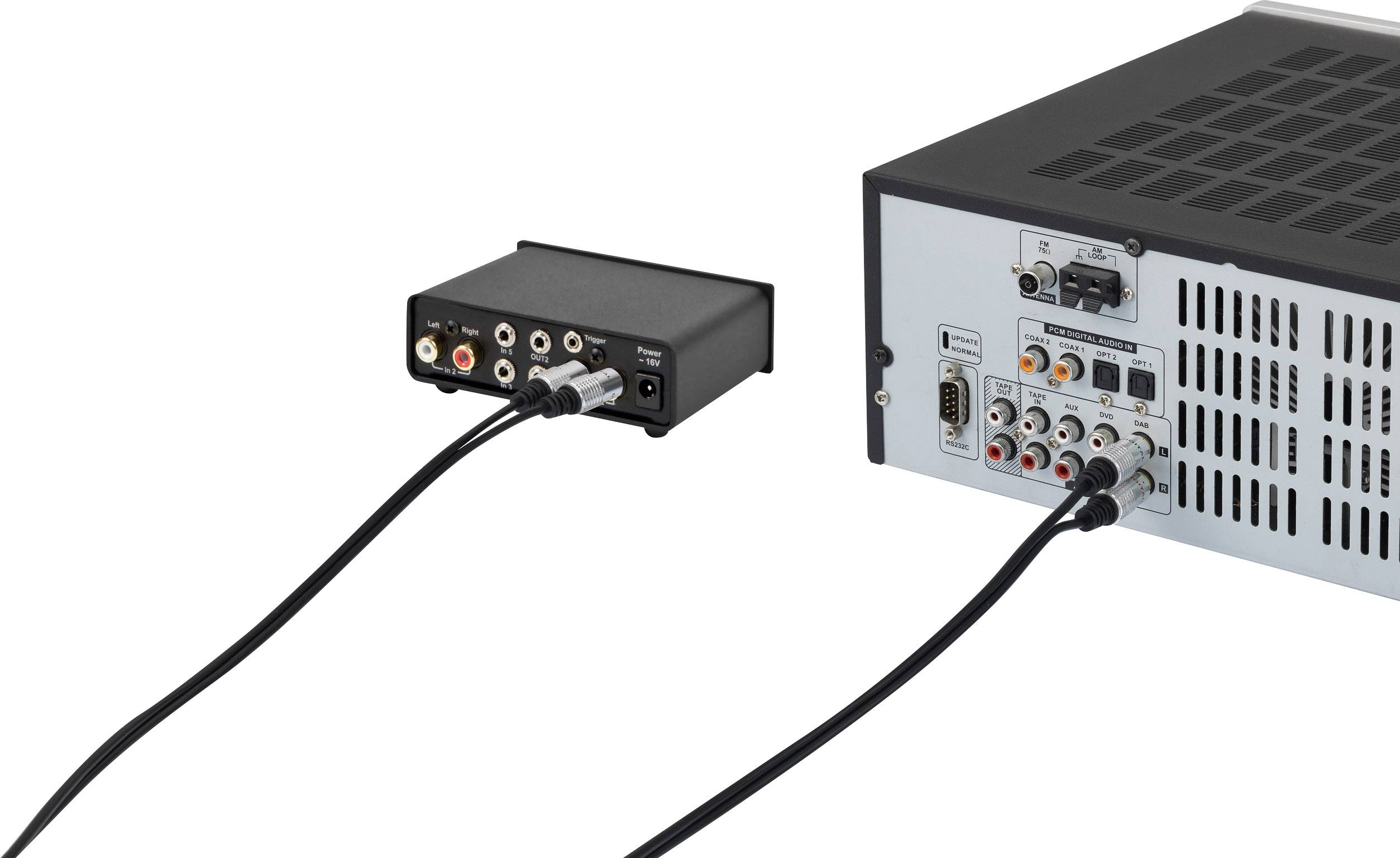 Two audio devices connected by cables; on the left, a small black device with RCA connectors, on the right, a larger device with multiple ports.