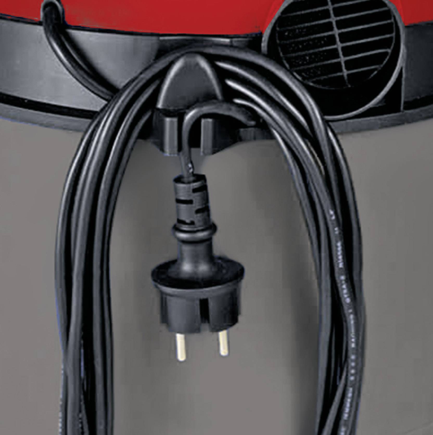 A black network cable with a European plug hangs from the front of a grey and red device, presumably a vacuum cleaner.