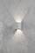 Wall light with a square casing radiates light upwards and downwards onto a roughly textured, grey wall. Minimalist design.