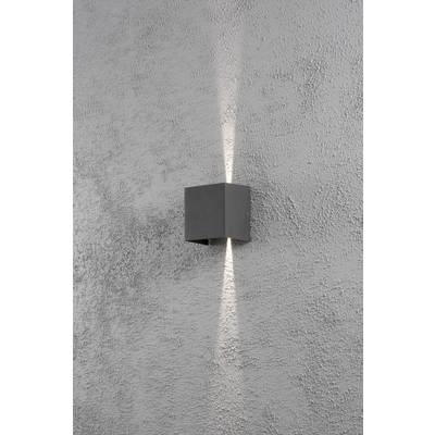 Wall light on a grey wall, radiating light upwards and downwards, creating a decorative effect.