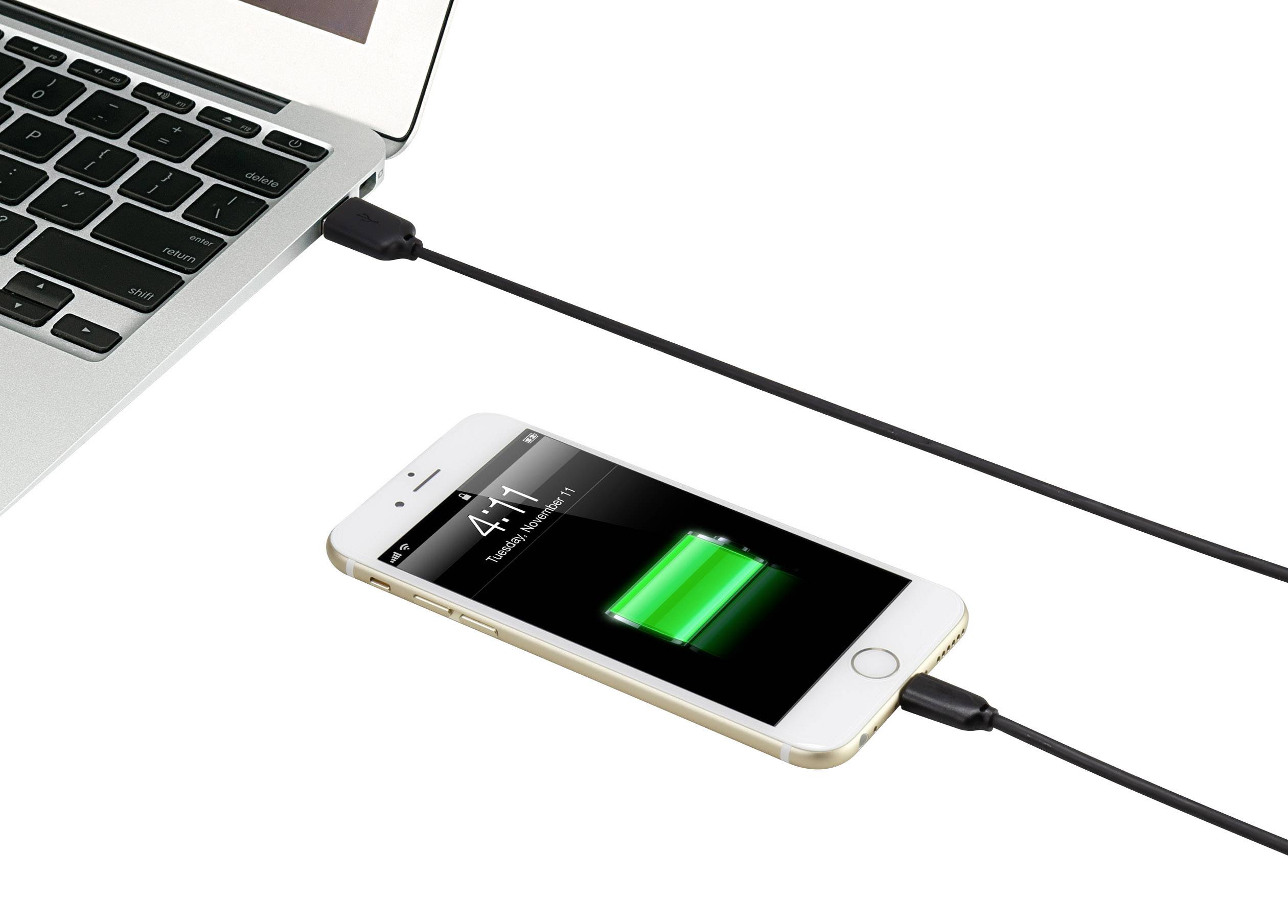 A smartphone is connected to a laptop via a cable and is being charged. The smartphone's screen displays a charging bar.