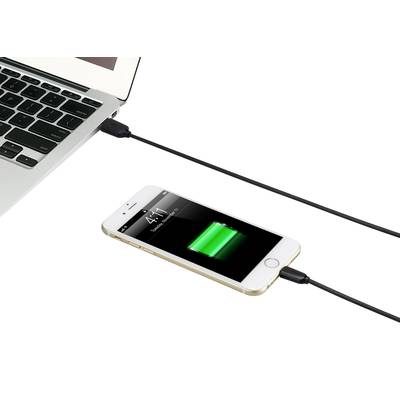 A smartphone is connected to a laptop via a cable and is being charged. The smartphone's screen displays a charging bar.
