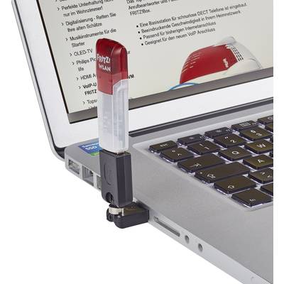 A laptop with a Wi-Fi dongle plugged into a USB port. Technical details are visible on the screen.