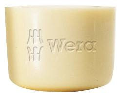 A cream-coloured piece of polishing paste by Wera, cylindrically shaped, with the embossed logo and text 'Wera'.