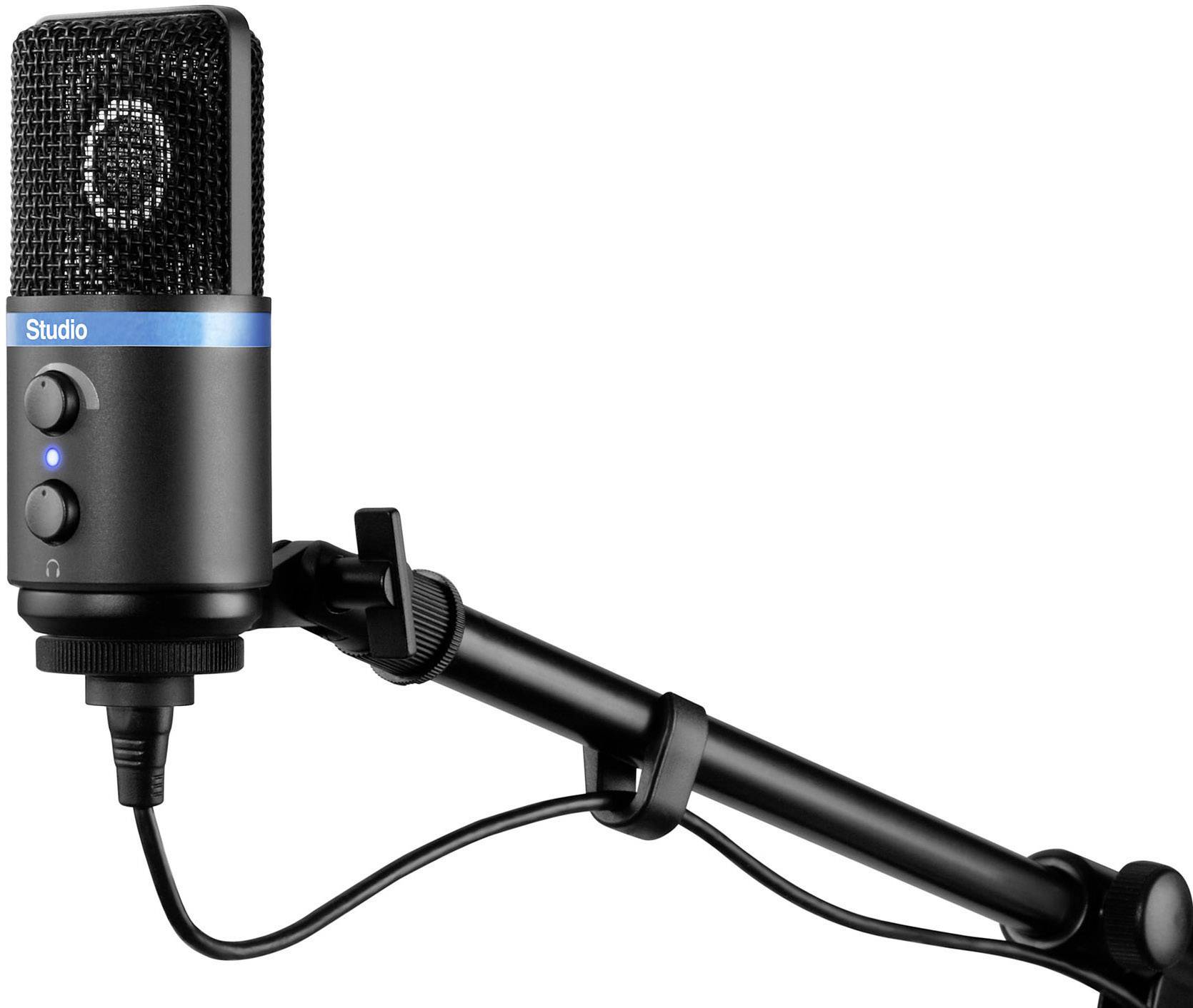 A black studio microphone with a blue band and two controls is mounted on an adjustable arm.