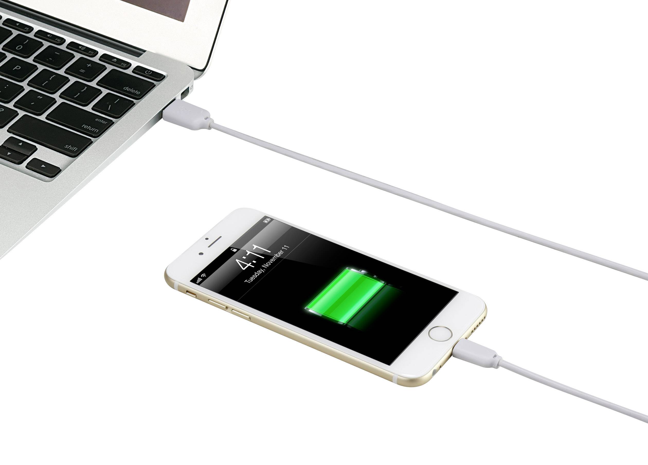 A smartphone is being charged via a cable from a laptop, with the screen displaying the charging process through a green battery icon.