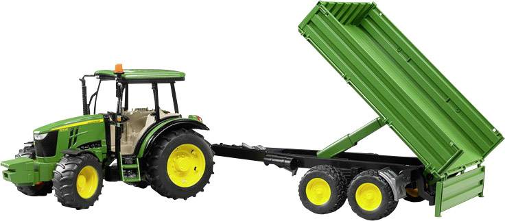 A green tractor with yellow wheels is pulling a trailer with its loading area raised.