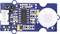 'Blue and white motion sensor with circuit components, including a large black chip and a white circular element on the right.'