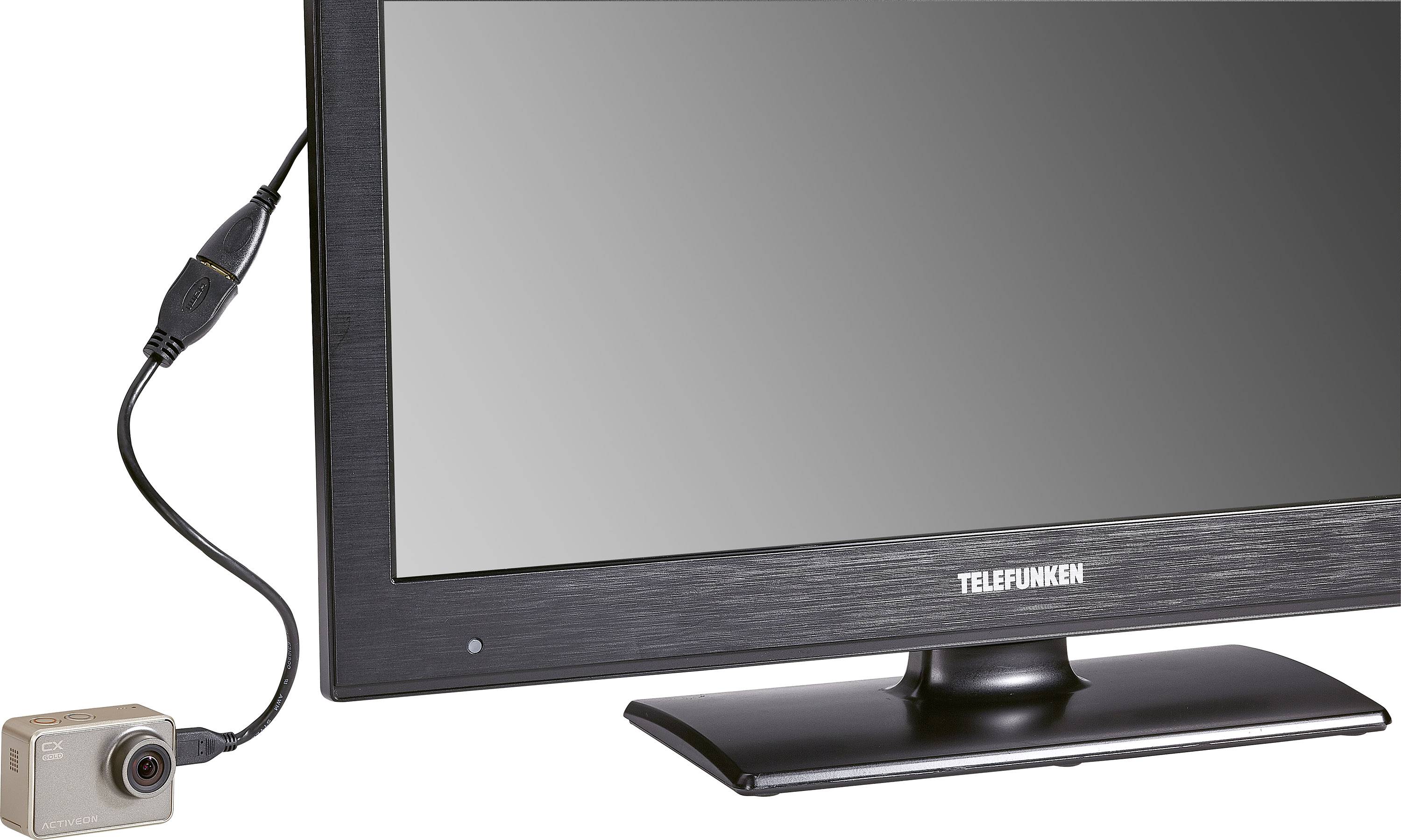 A Telefunken television is connected to a small camera via a cable.