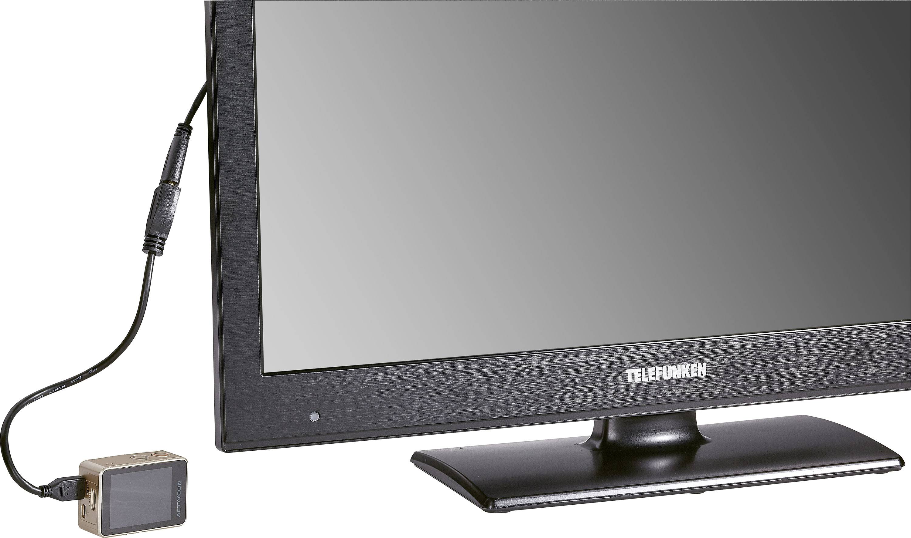 A monitor displaying the 'TELEFUNKEN' branding, connected via a cable to a small external device on the left. The screen is switched off.